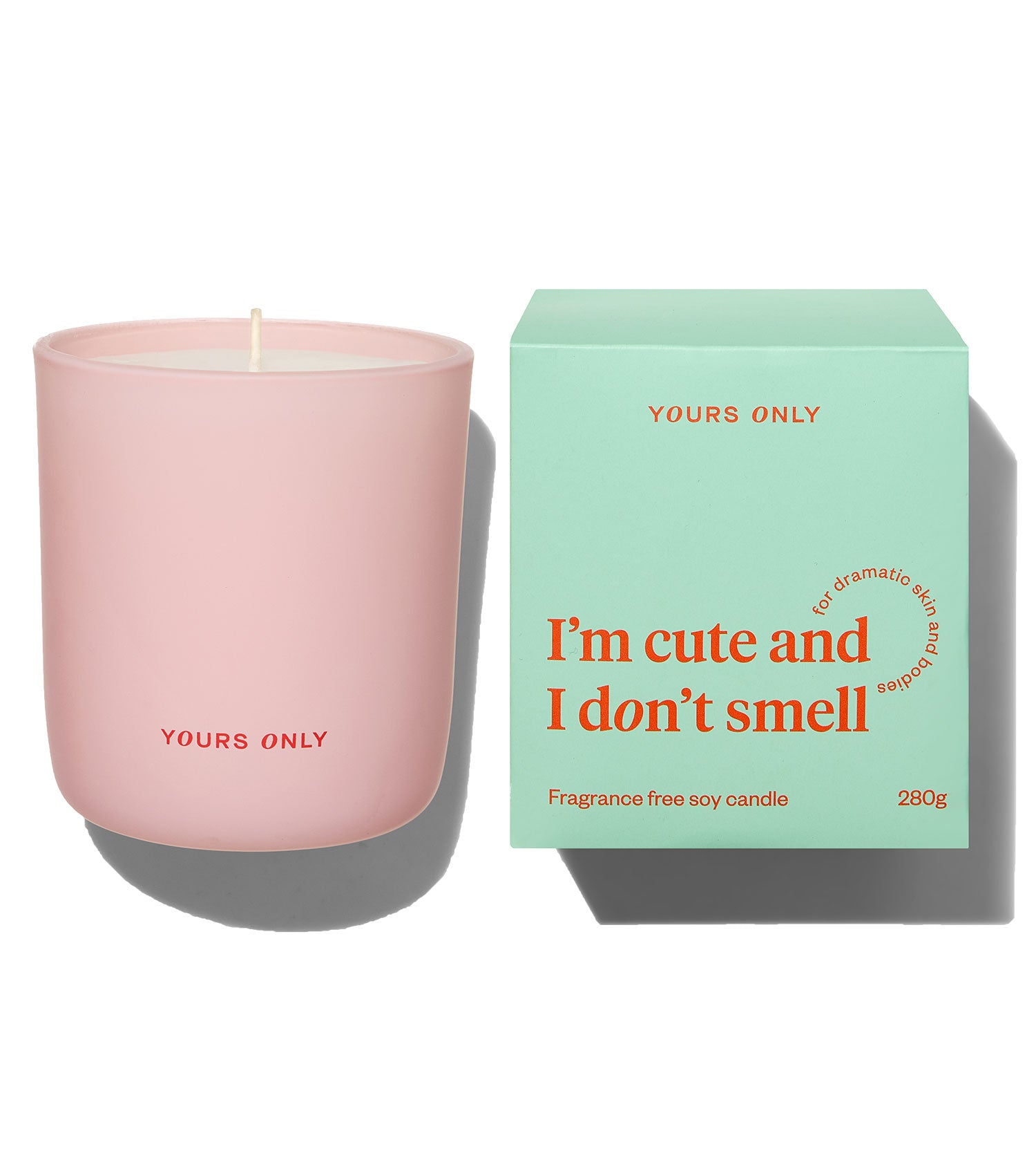 Yours Only fragrance free soy candle in a pink glass jar next to its green box