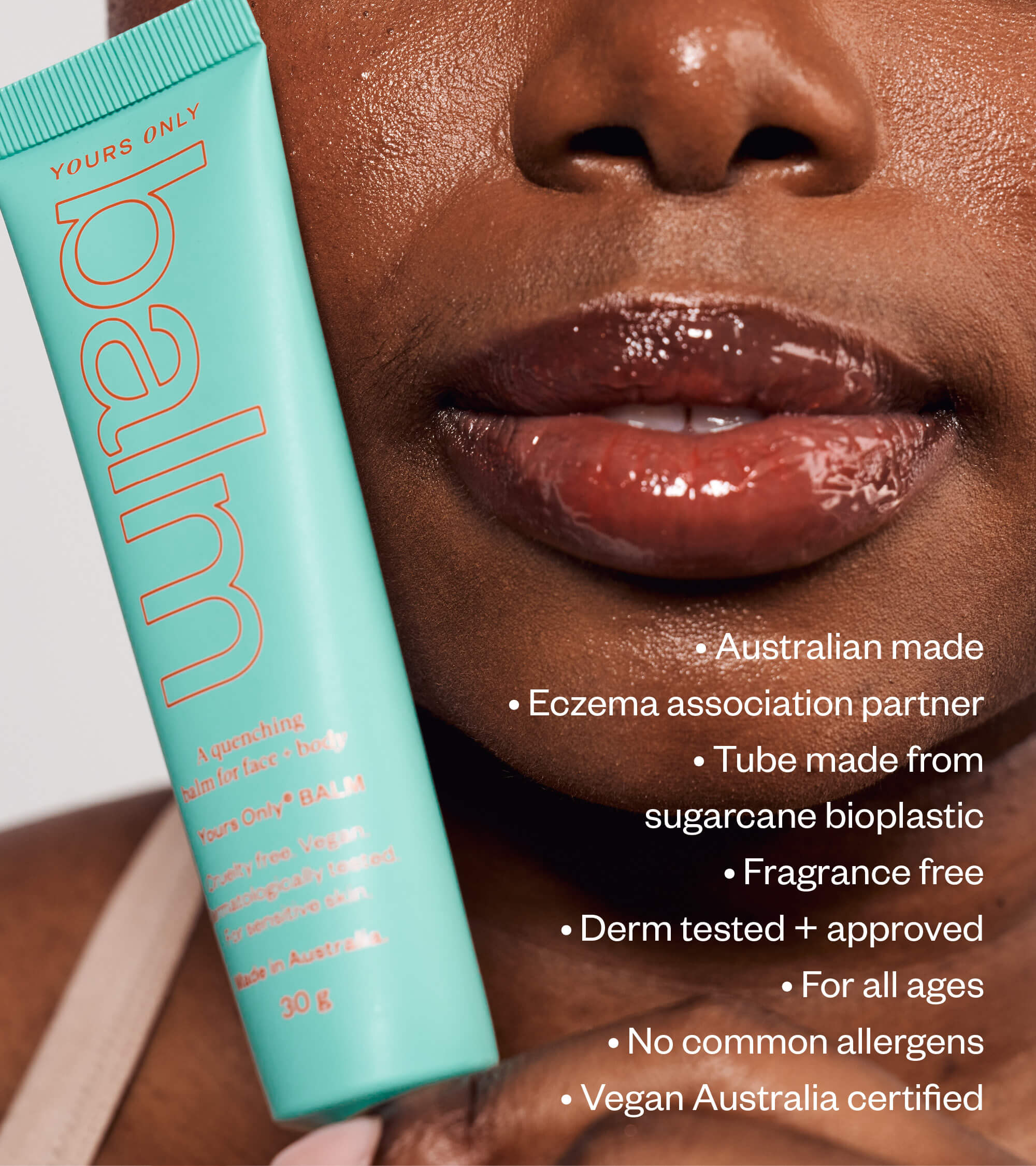 Close up of a person holding The Soothing Bundle balm with product features listed