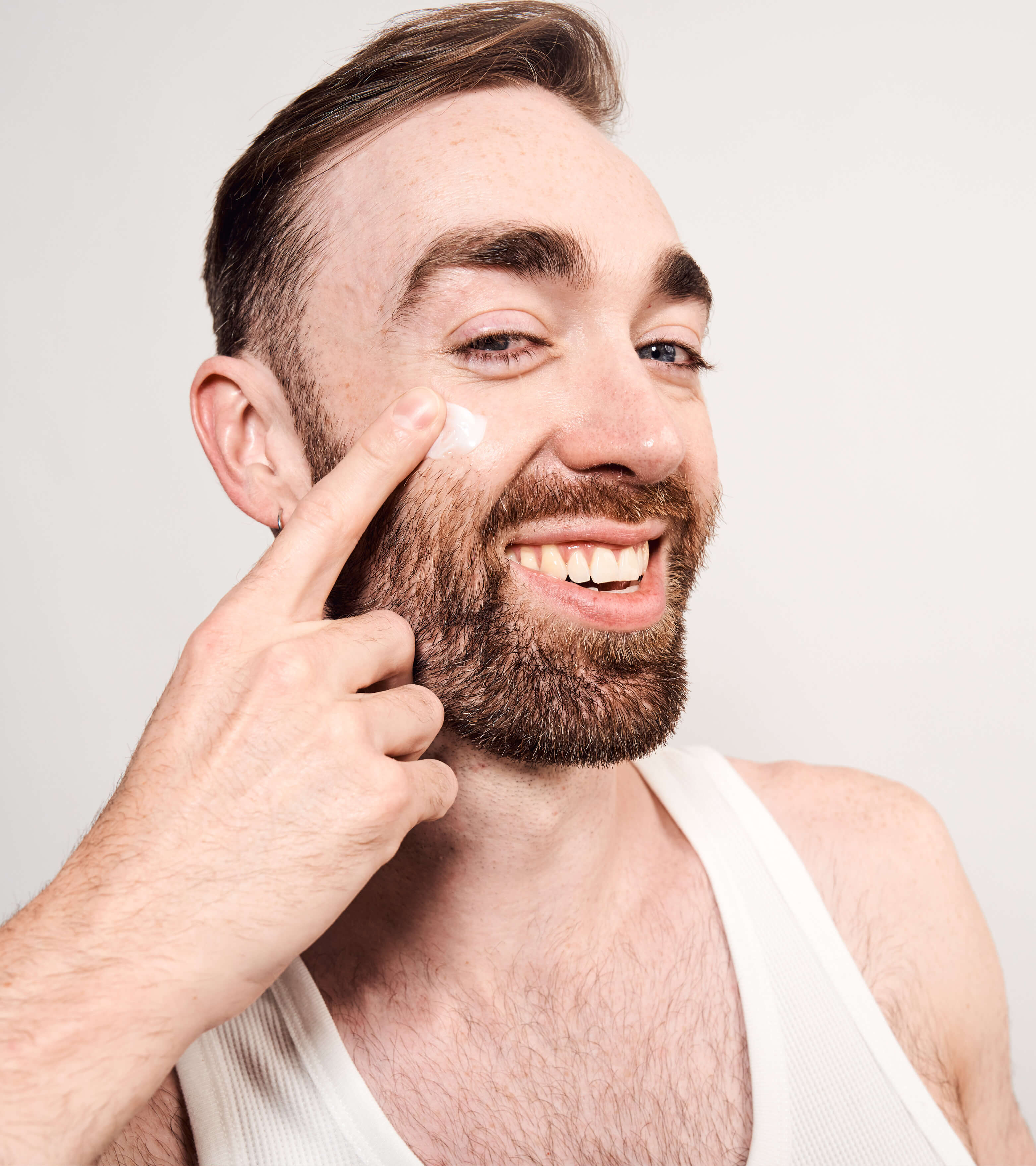 Man with beard applying 2 x coat 100mL to his cheek