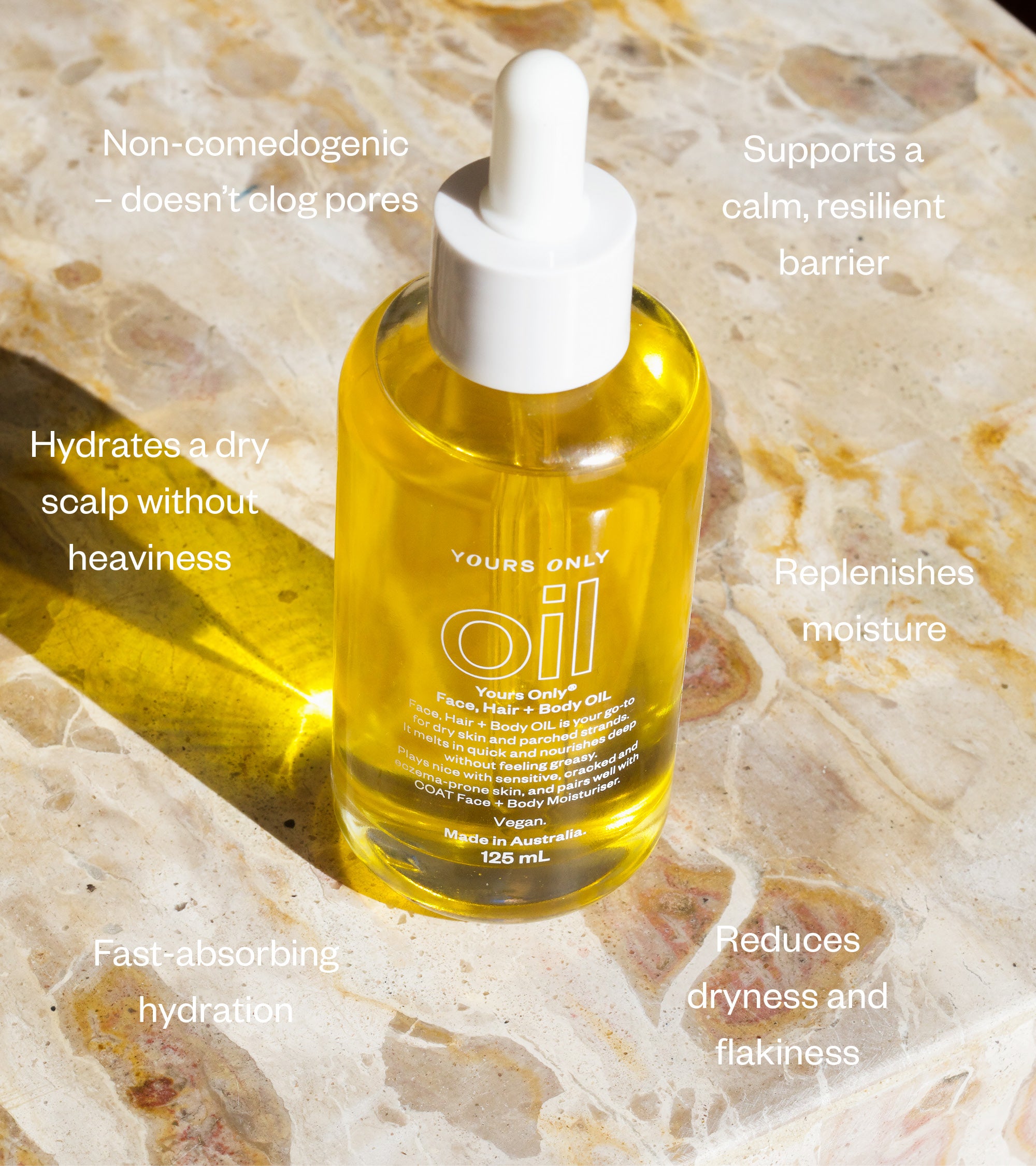 Bottle of 'Yours Only' oil with text highlighting its benefits on a stone surface