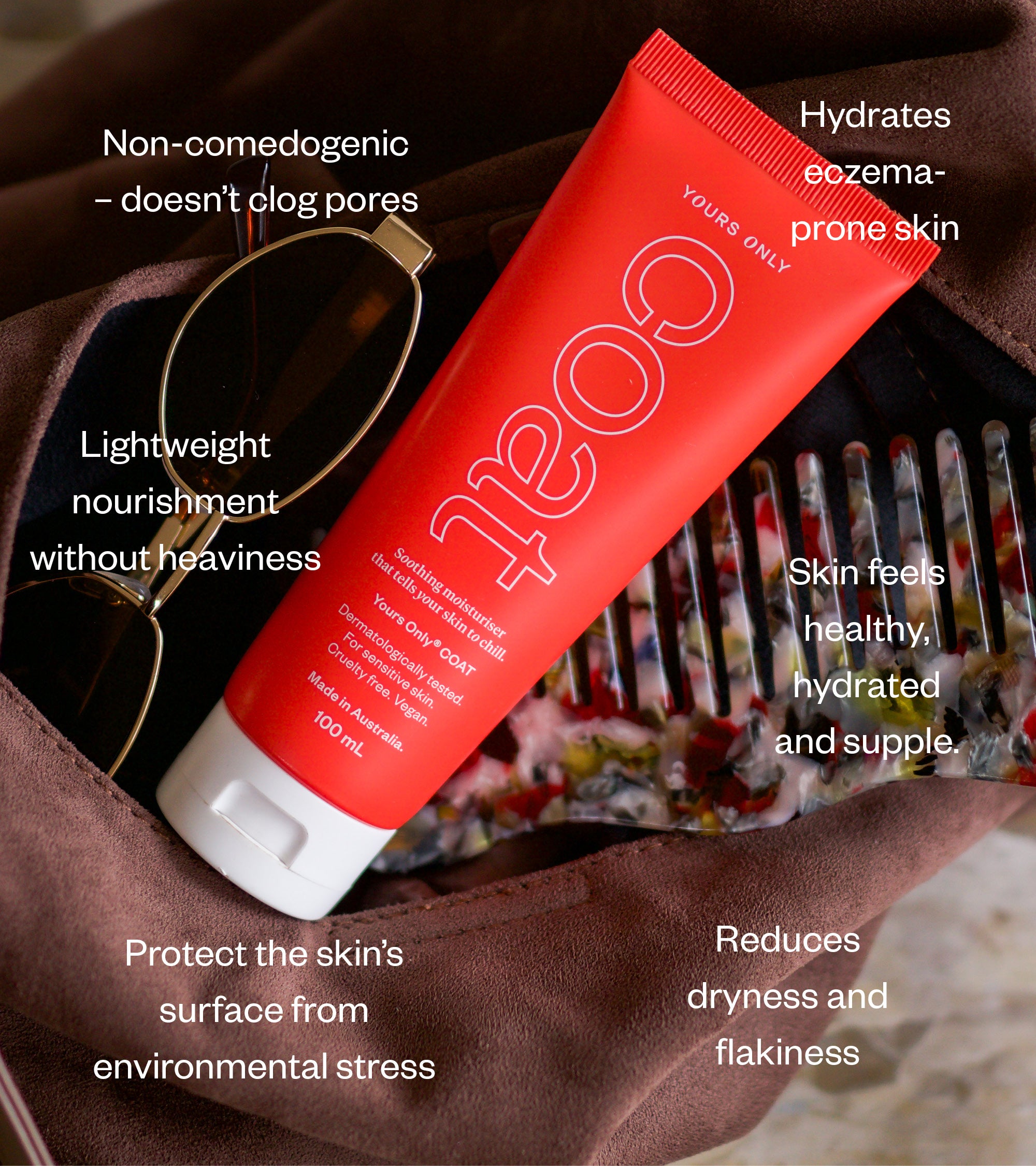 Red tube of skincare product with text highlighting benefits, placed in a brown bag with sunglasses and a comb.