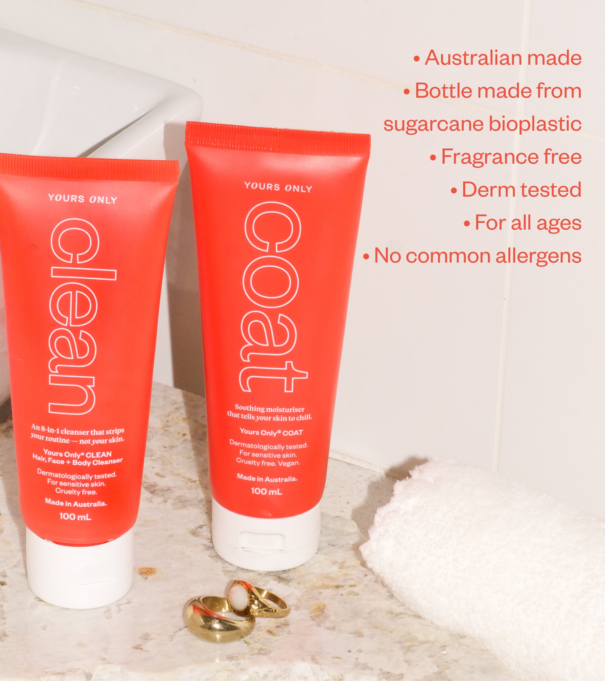 Clean + Coat 100mL bundle with two red and white tubes, a white towel, and two rings on a marble surface