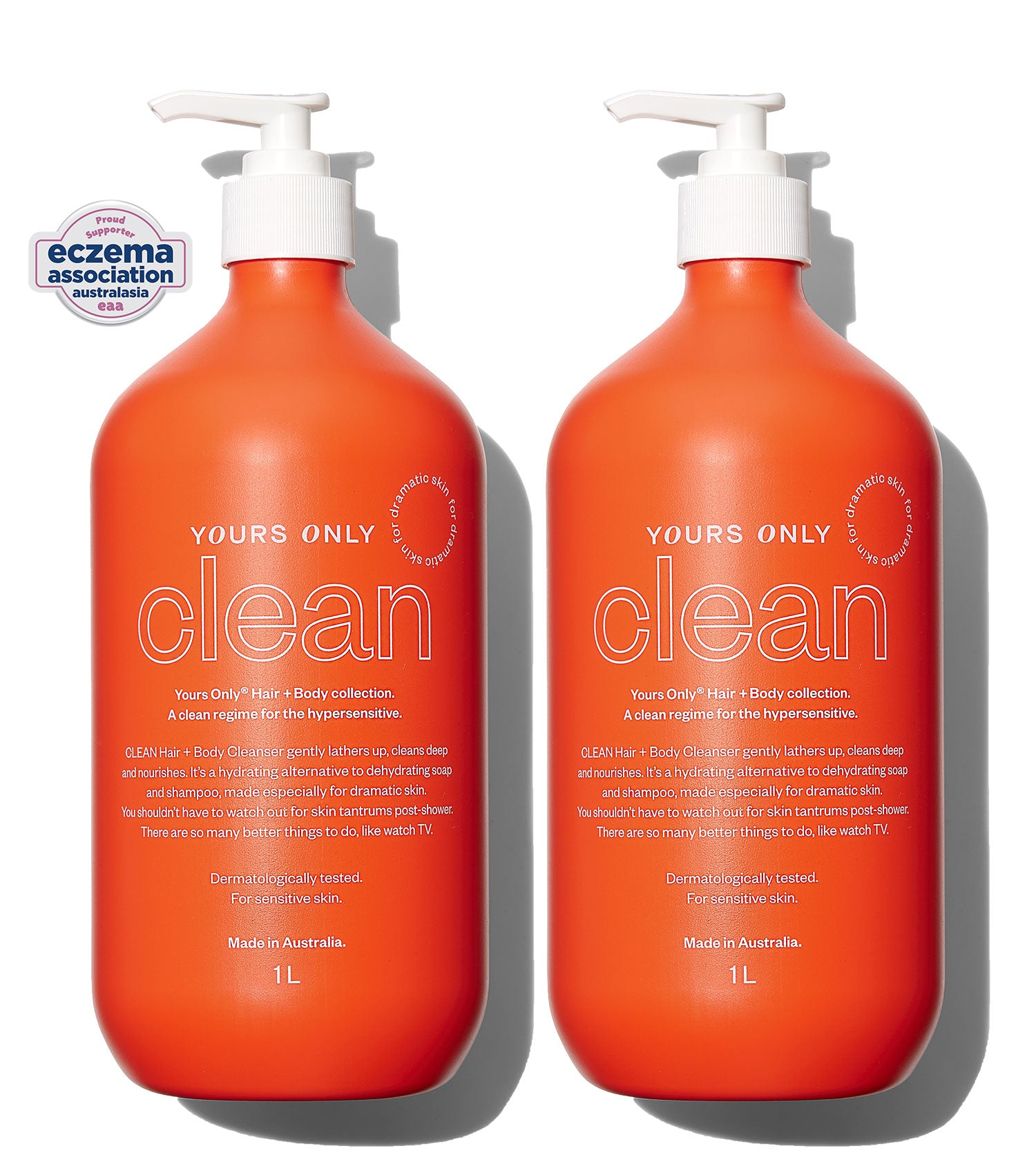 Two 1L orange bottles of Yours Only Clean Hair + Body Cleanser with white pumps